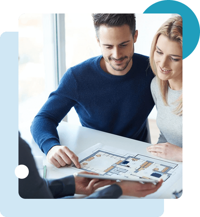 A man and woman looking at a house plan.